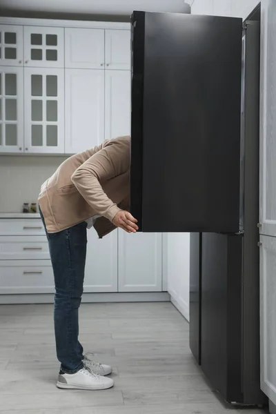 Young Man Looking Open Refrigerator Kitchen — Stock Photo, Image