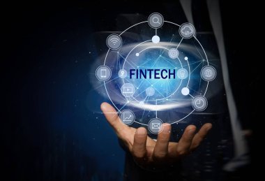 Fintech konsepti. Koyu mavi arkaplanda farklı simgeler gösteren adam, yakın plan