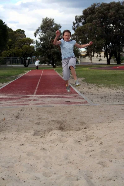 Young Girl Very High Long Jumping Stock Photo