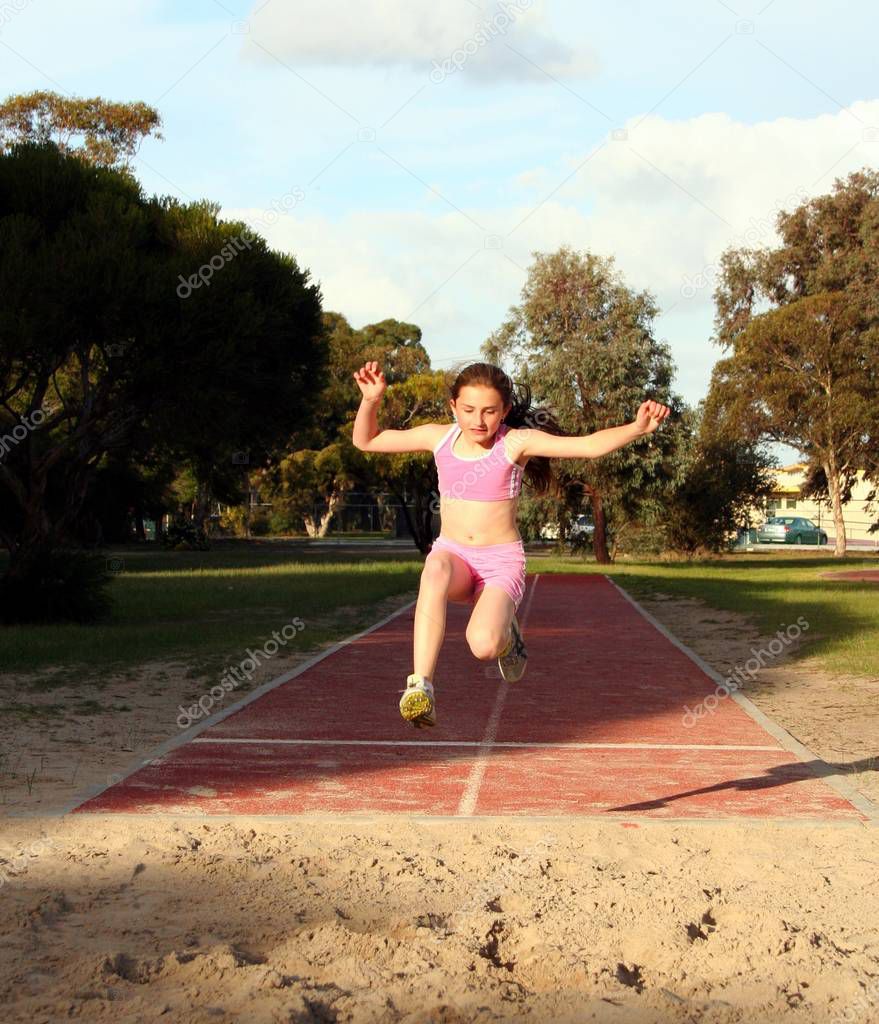 Young girl very high long jumping