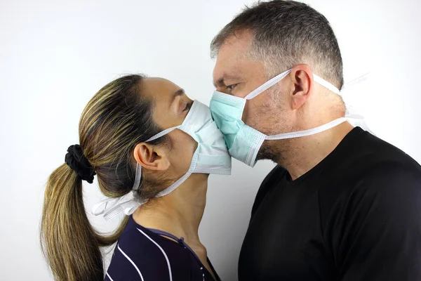 Couple wearing a virus face mask kissing concept for corona virus