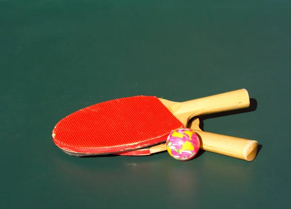 Ping pong bats and ball on table