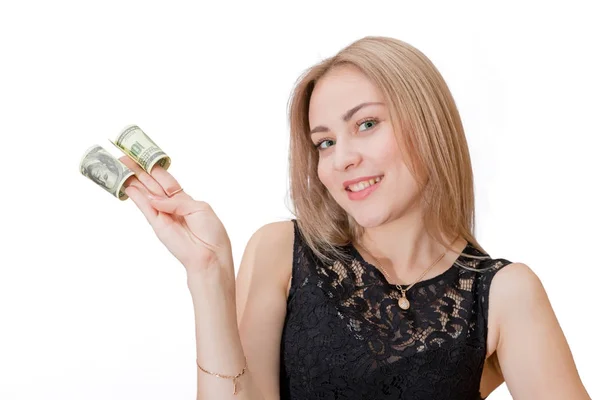 Beautiful young blonde holding between the fingers twisted dolla — Stock Photo, Image