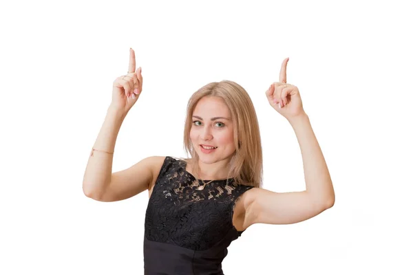 Smiling young woman with blond hair in jacket pointing finger up — Stock Photo, Image