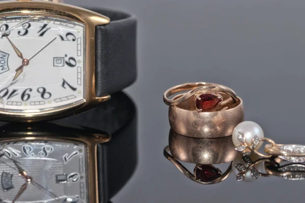 女性の金のイヤリングと、れたらに婚約指輪ペア — ストック写真