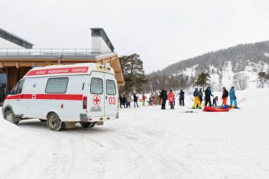 The ambulance staff provided first aid to the injured skier at a clipart