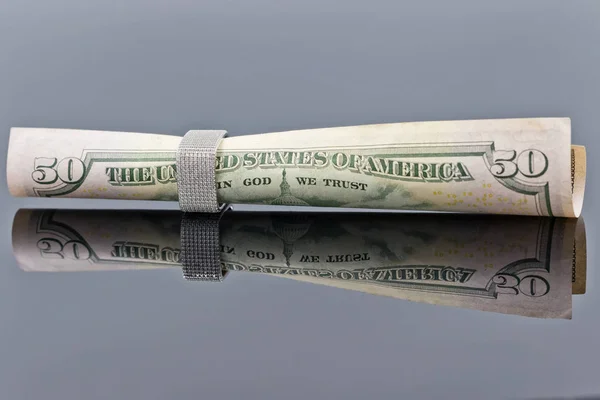 Fifty dollar bill is rolled into elegant women's silver ring — Stock Photo, Image