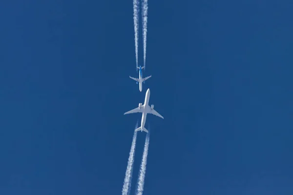 Two planes flying on opposite courses meet in the sky