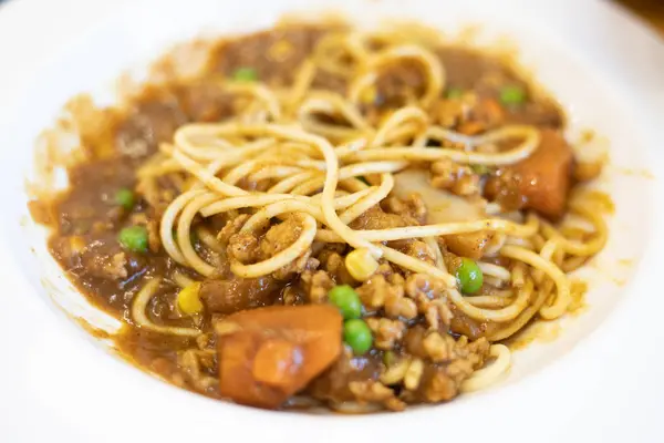 Spaghetti al curry in un piatto bianco . — Foto Stock