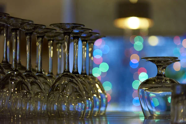 Empty glasses on a shelf in the background of a bokeh