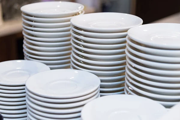 White plates stacked in piles