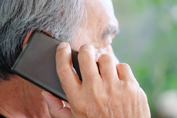 Senior man enjoying on his phone — Stock Photo, Image