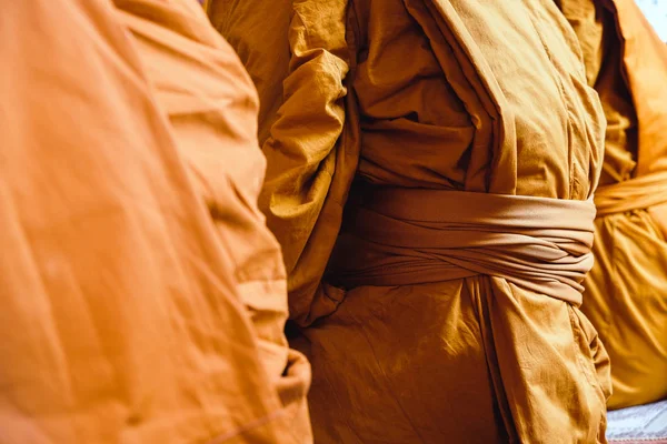Yellow robe of Buddhist monks, Closeup on buddhist monk