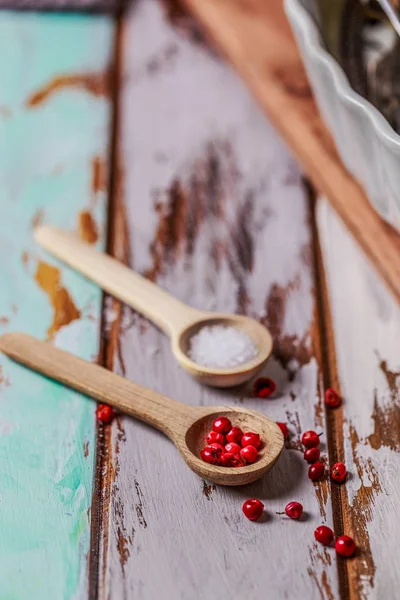 Wood spoon with salt and pepper on wood background — Stock Photo, Image