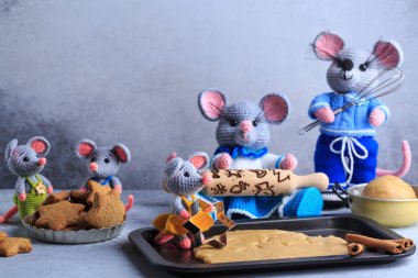 Knitted mouse family is cooking cookies. Year of rat. symbol of 2020. clipart