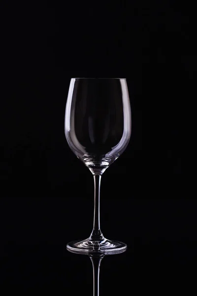 Empty Glass for wine on black background. Empty Glass of wine on black background. Wine on the dark
