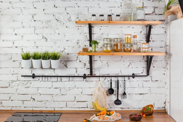 Interior da cozinha moderna parede de tijolo branco zero conceito de resíduos frascos de vidro malha saco de reutilização — Fotografia de Stock