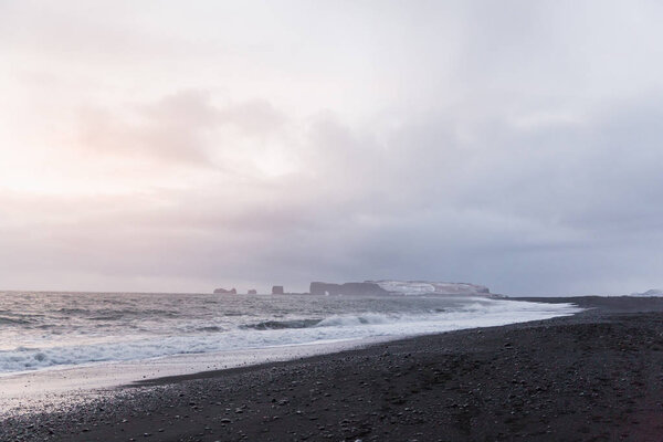 magestic seacoast with wavy sea and cliffs, vik dyrholaey, reynisfjara beach, iceland
