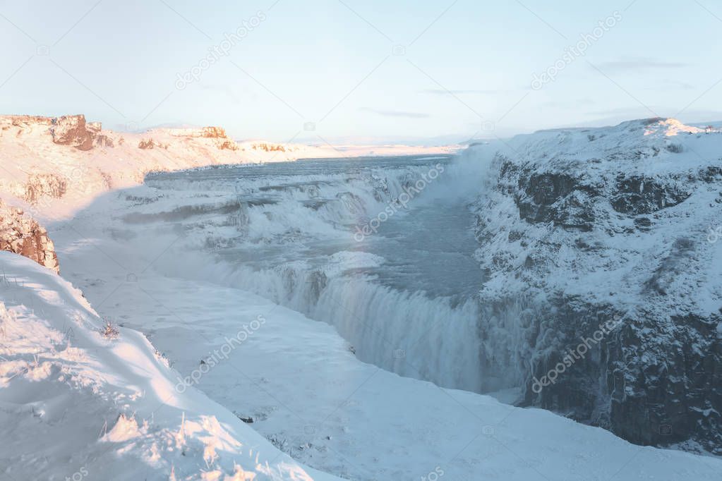 beautiful icelandic landscape with snow-covered rocks and Gullfoss waterfall