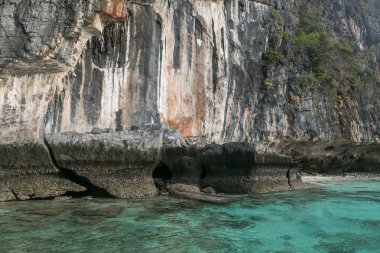 beautiful scenic view of rocky formations covered with plants and ocean, phi phi islands clipart