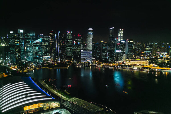 SINGAPORE - JAN 19, 2016: urban view of buildings and city river at night