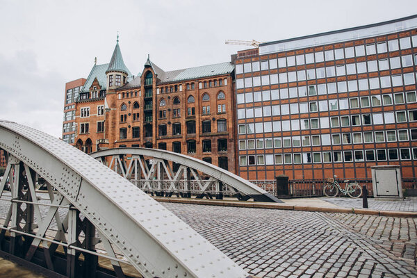 urban scene with bridge and buildings at old warehouse city district in hamburg, germany