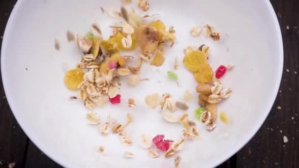 Close-up of muesli poured in a white bowl — Stock Video