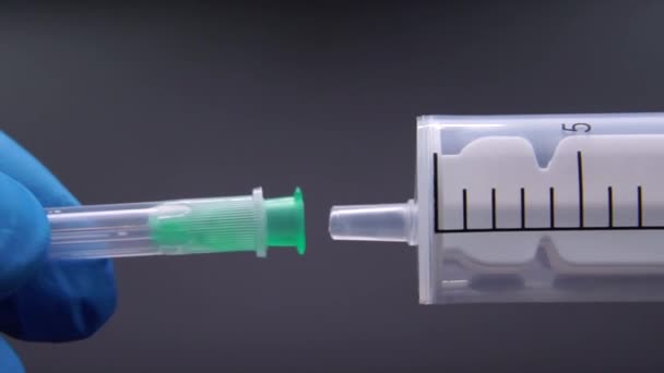 Le médecin fixe une aiguille à une seringue 