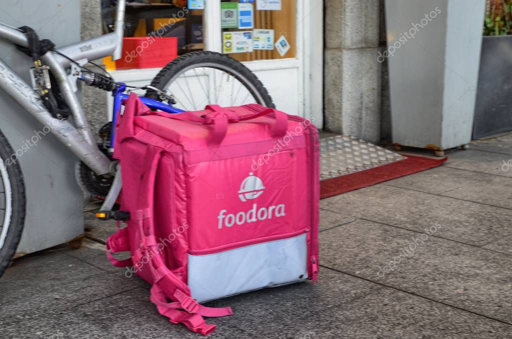 Turin, Piedmont, Italy. April 13 2018. The bike and the bag of a foodora worker. Foodora deals with home delivery of food.