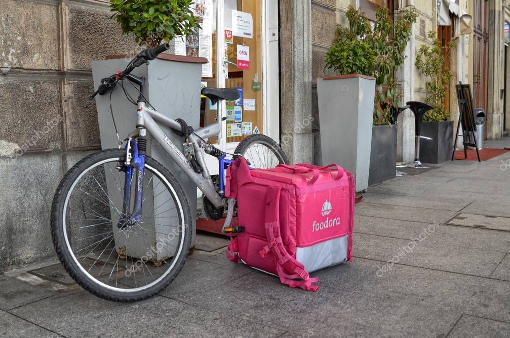 Turin, Piedmont, Italy. April 13 2018. The bike and the bag of a foodora worker. Foodora deals with home delivery of food.