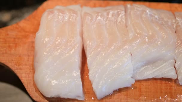 Close Footage Cod Fillet Placed Wooden Cutting Board Cut Portions — Stock Video