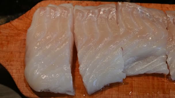 Close Footage Cod Fillet Placed Wooden Cutting Board Cut Portions — Stock Video
