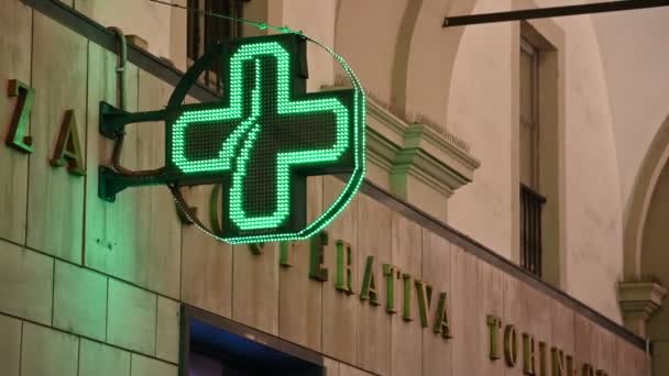 Turin, Piedmont region, Italy. January 2020. Illuminated sign of a pharmacy. The characteristic shape and the typical green color make it immediately identifiable. — Stock Video