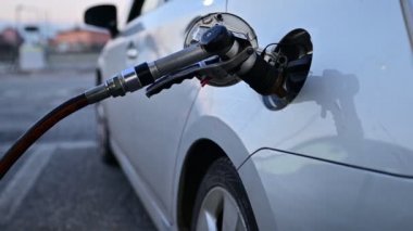 Yakıt ikmali sırasında LPG pompalı tüfek, metalik gri araba, video.