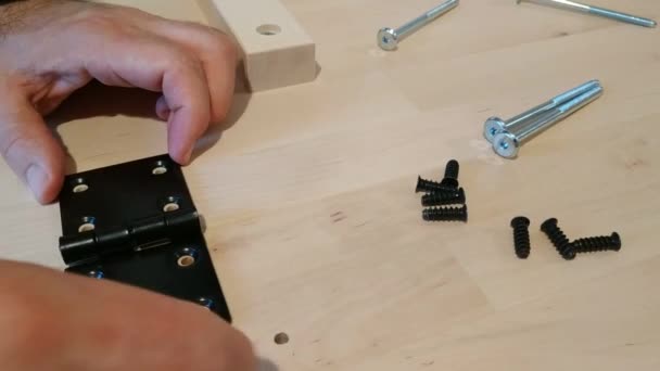 Fixing Black Metal Hinge Two Light Wooden Boards One Hand — Stock Video