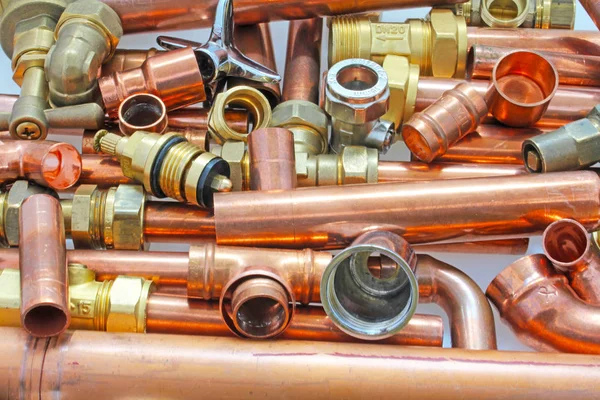 Plumber\'s pipes , fittings and wrenches  website banner    wide  random mixture of copper pipe, brass fittings  and wrenches ideal for use as a website header  background