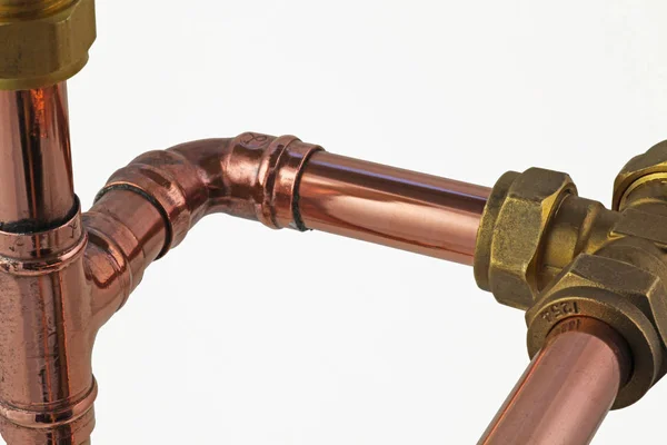 Copper pipework   Copper pipe, compression and solder fittings isolated on a white background,