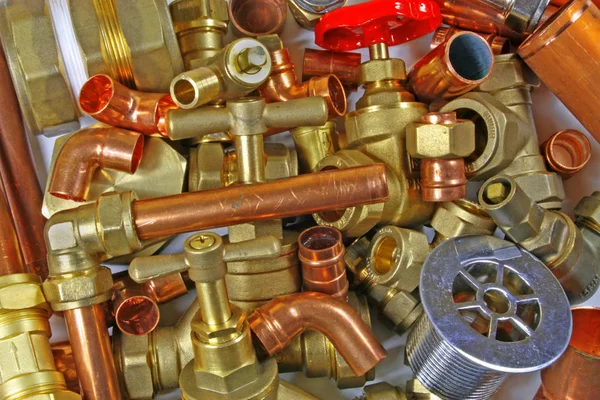 Plumber\'s pipes and fittings       Random mixture of copper pipe and brass fittings ideal for use as a website header  background