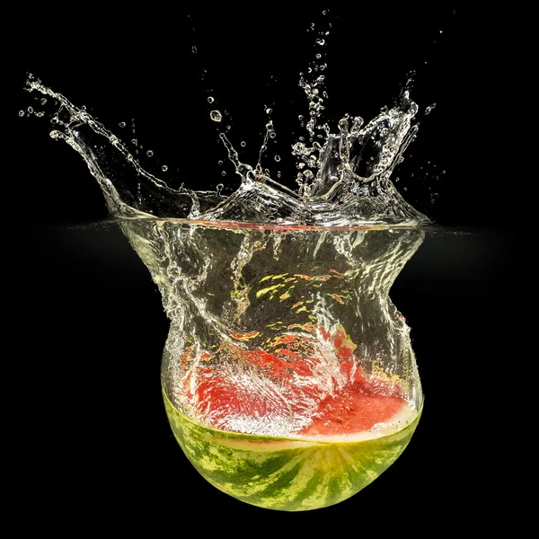 Fresh melon falling in water with splash on black background — Stock Photo, Image