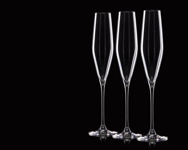 Ensemble de verres à champagne de luxe vides dans une rangée isolé sur un fond noir — Photo