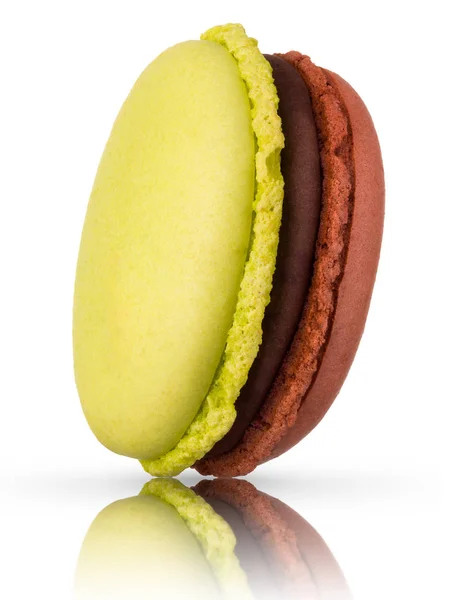 Macro photo of french caramel and pistachio macaroon isolated on white — 스톡 사진