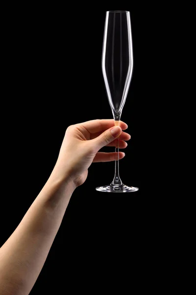 Mulher mão segurando copo vazio de champanhe isolado em preto . — Fotografia de Stock