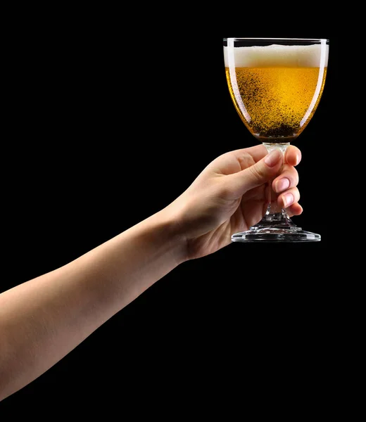 Woman hand holding lager beer glass isolated on black. — Stock Photo, Image