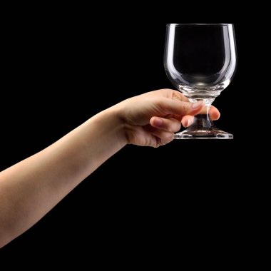 Woman hand holding empty beer glass isolated on black.