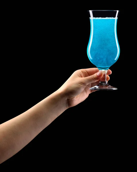 Woman hand holding blue cocktail glass isolated on black. — Stockfoto