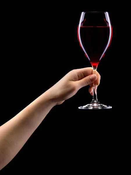 Woman hand holding red wine glass isolated on black. — Stok fotoğraf