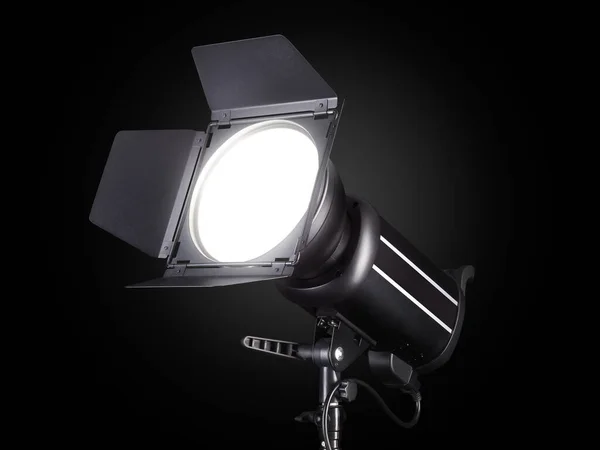 Photography studio flash isolated on black background with lamp. — Stockfoto