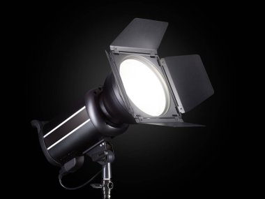 Photography studio flash isolated on black background with lamp.