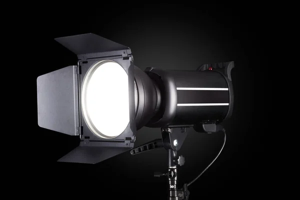 Photography studio flash isolated on black background with lamp. — Zdjęcie stockowe