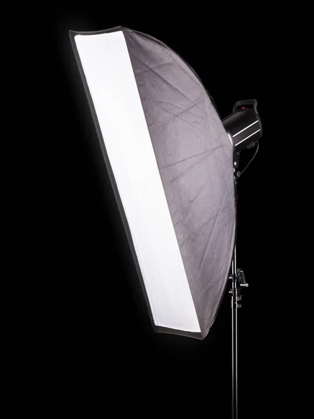 Stojaki oświetleniowe studio fotograficzne z lampą błyskową i softbox izolowane na czarno. — Zdjęcie stockowe